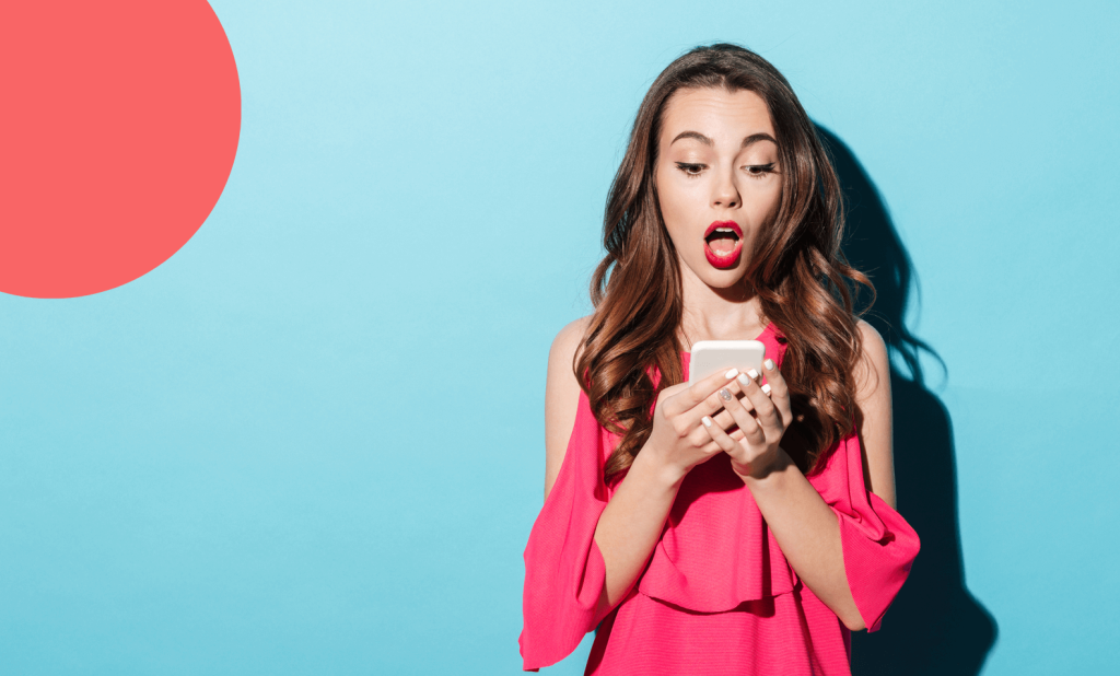 girl surprised looking at a smartphone.